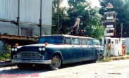 Une limousine à vendre.<br>C'est sûrement un prix intéressant.<br>En plus, elle a 8 portes: 4 à droite et 4 à gauche !<br>Quelques menues réparations à prévoir: pneus etc...<br>On se demande qui est le plus ancien, de la station essence ou de la voiture...